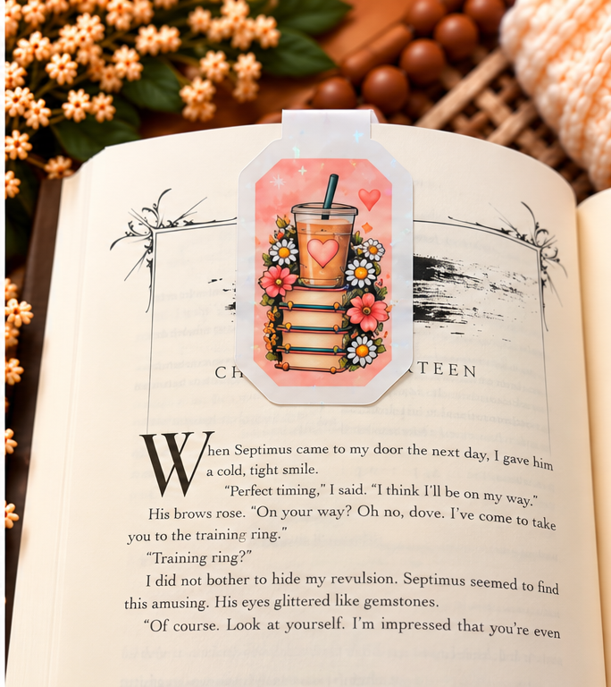 Fueled by Books and Iced Coffee magnetic bookmark reverse side clipped over an open book