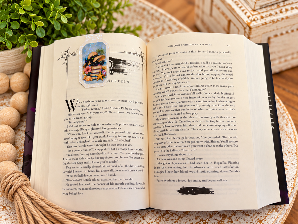 Back of Books Take Me to Happy Places magnetic bookmark clipped over an open book
