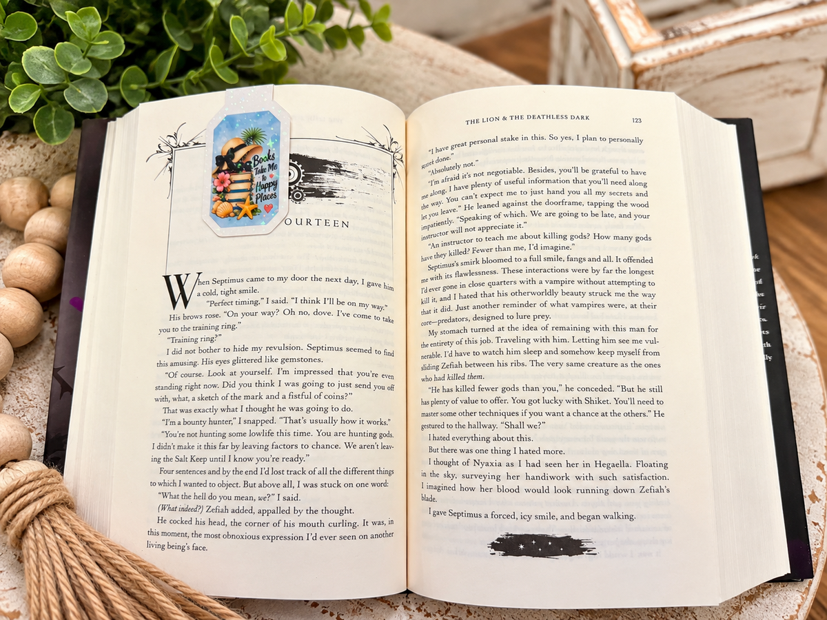 Books Take Me to Happy Places magnetic bookmark clipped over an open book