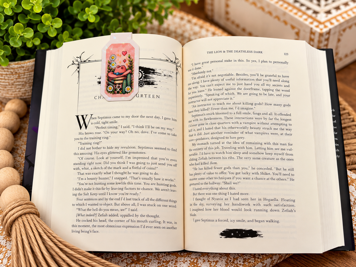 Back of Cowgirl Reads magnetic bookmark clipped over an open book