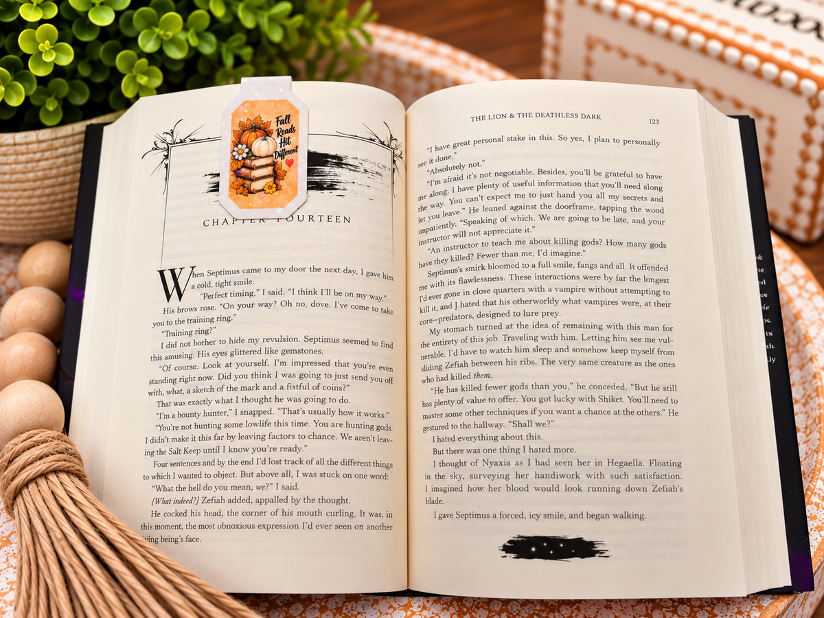 Fall Reads Hit Different magnetic bookmark clipped over an open book