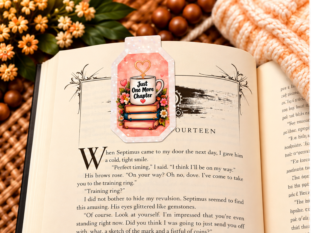 Just One More Chapter magnetic bookmark front clipped over an open book