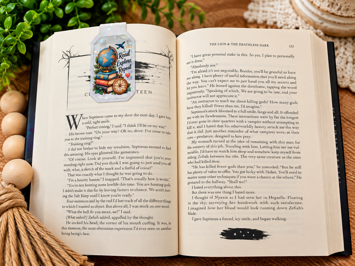 Read Explore Repeat magnetic bookmark front shown on an open book